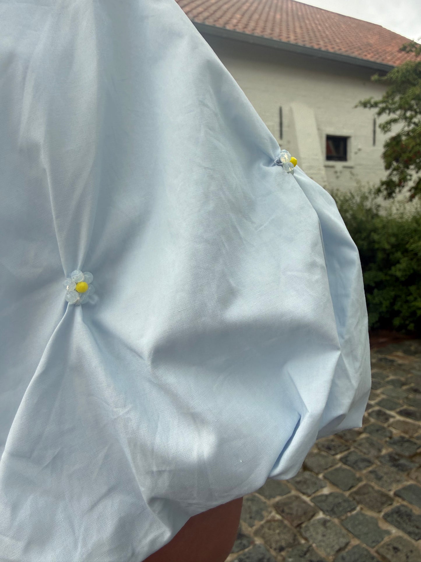 Blauwe blouse met ballonmouw & detailknopen